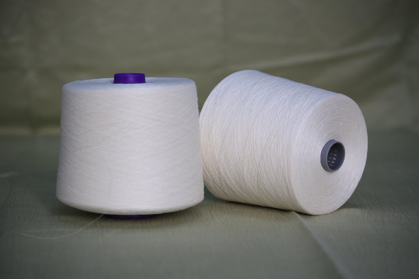 Two white textile yarn cones for yarn product presentation